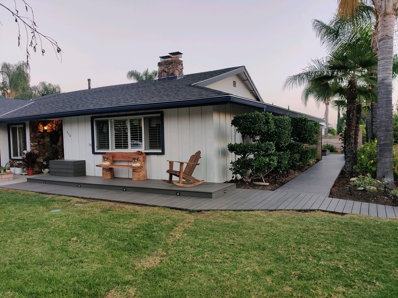 Outdoor deck and walkway beside a house with integrated step lights